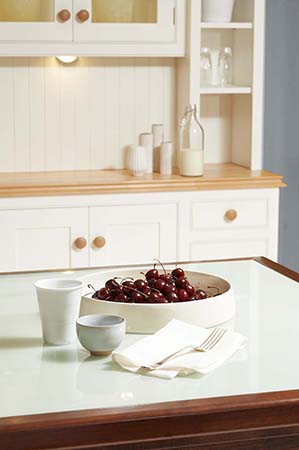 Doherty kitchens and furniture makers-ivory painted dresser and Walnut Island with stepped draw detail and glass top