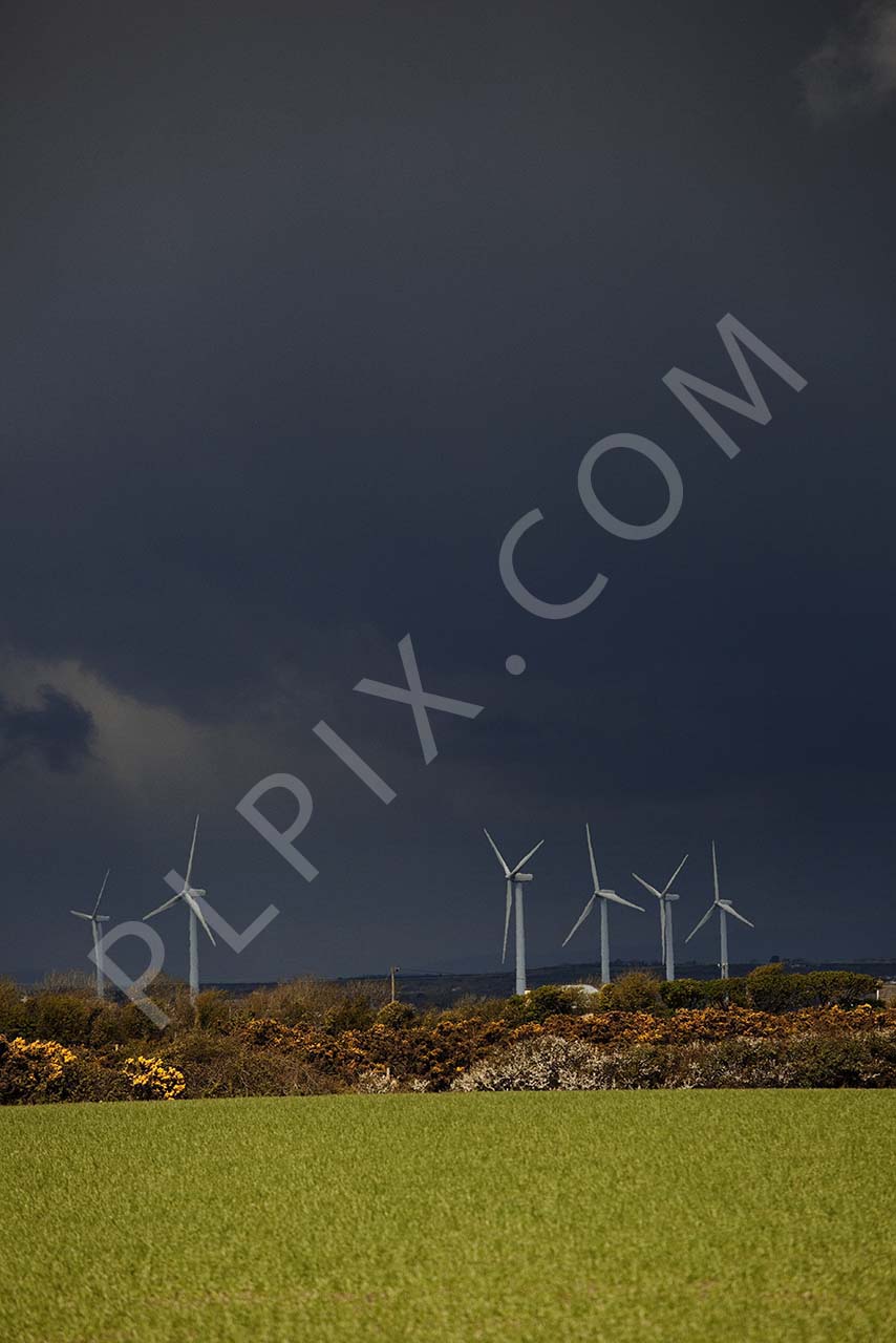 Royalty free stock image of wind turbines in a field a storm