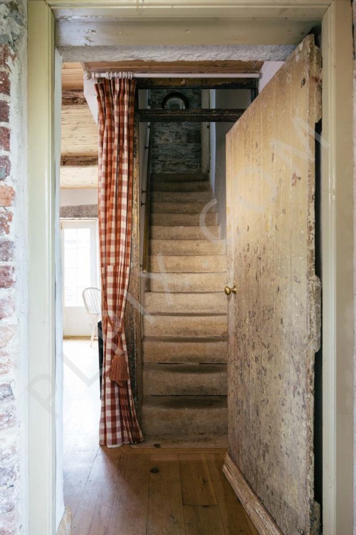 Hallway granite stairs aged timber door curtain