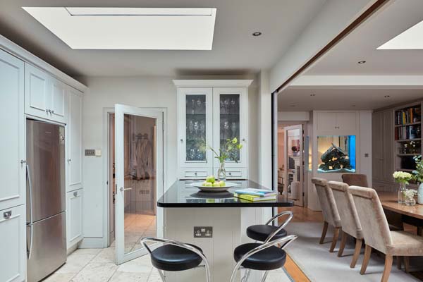 open plan kitchen dining area marble countertops sktlights storage sliding timber door