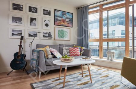 Living room openplan patio window floor lamp cushions rug coach artwork curtain