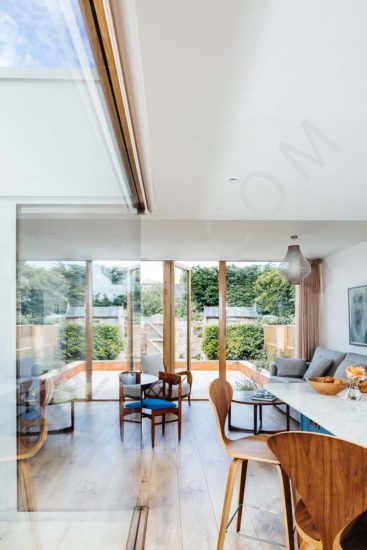 Kitchen restoration and extension with open plan dining and living room glass wall timber flooring pendant lighting garden views