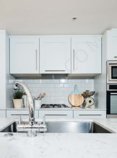 Kitchen restoration and extension with open plan dining details of storage marble countertop sink area