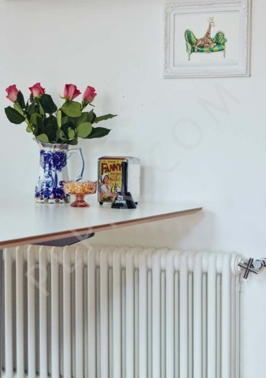 A contemporary retro restoration to a kitchen with a pink floor