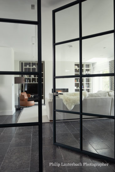 Open plan living room with stone fllooring storageglass door lounge chair sofa couch