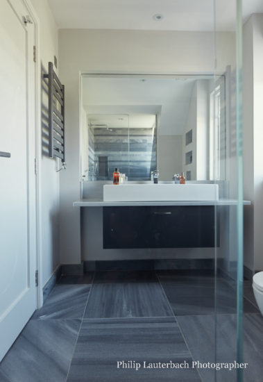 Bathroom mirror sink unit stone flooring