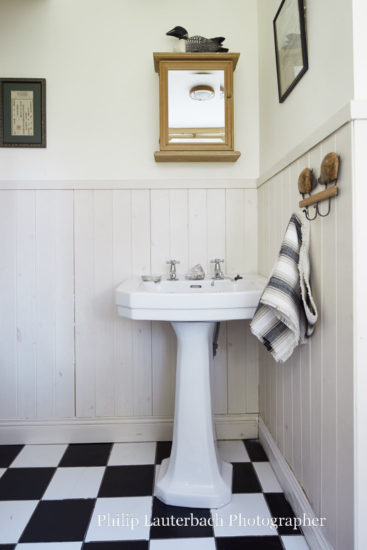 Bathroom floor tiling artwork timber panelling sink towel hooks