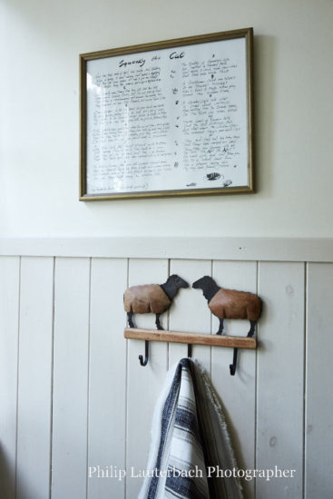 Bathroom detail of towel hooks artwork timber panelling