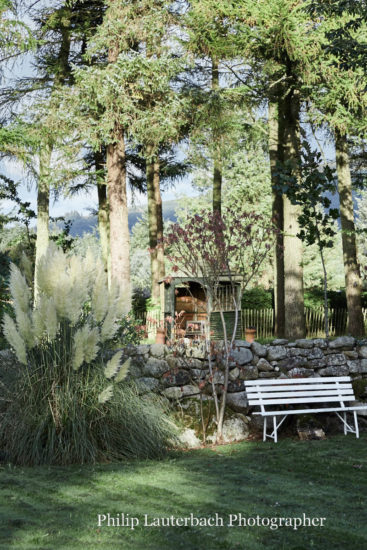 Exterior garden seating trees stone wall