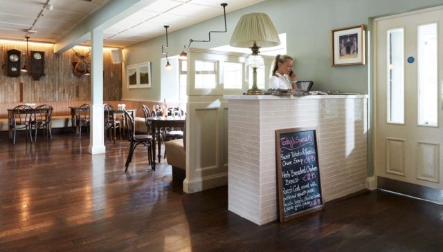 Bar seating tables timber panels pendant lighting